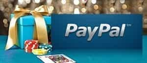 The PayPal logo next to a gift, playing cards and chips at a casino.