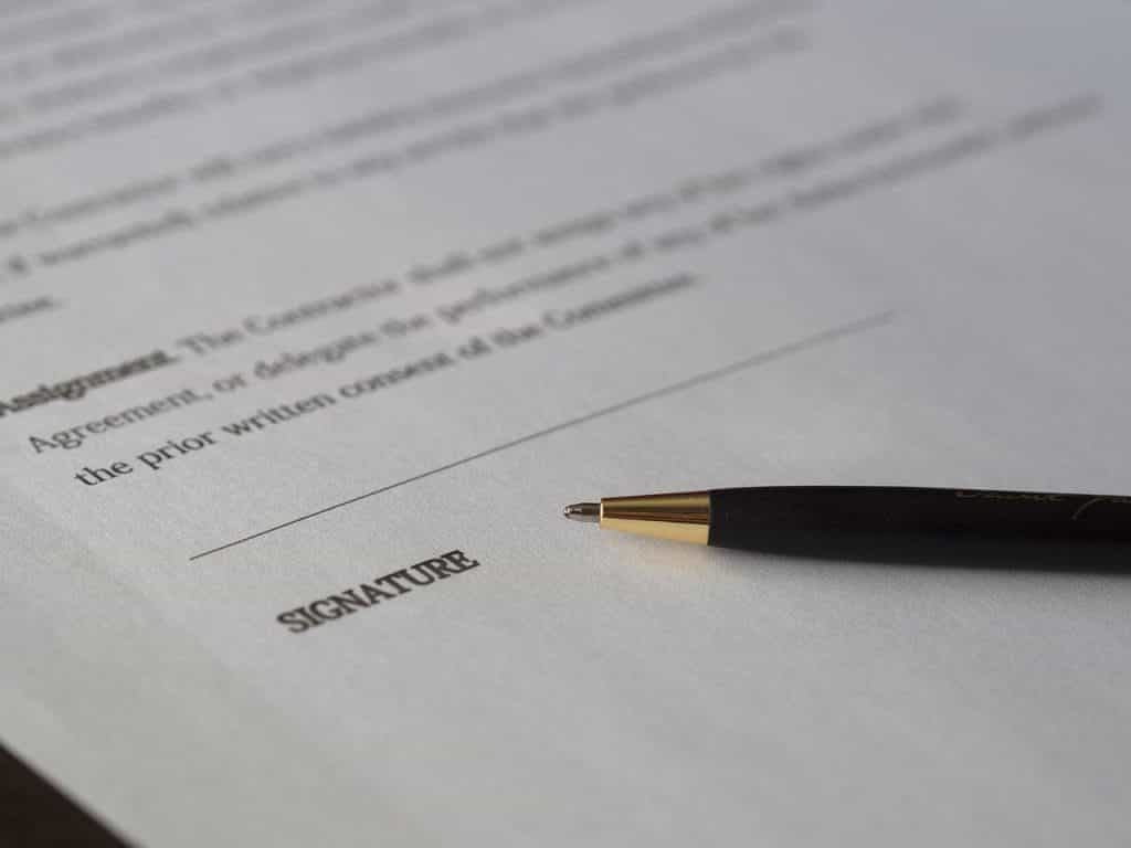 A contract with a pen on it, waiting to be signed.