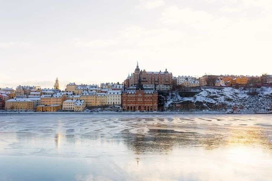 A frozen body of water with Stockholm in the background.