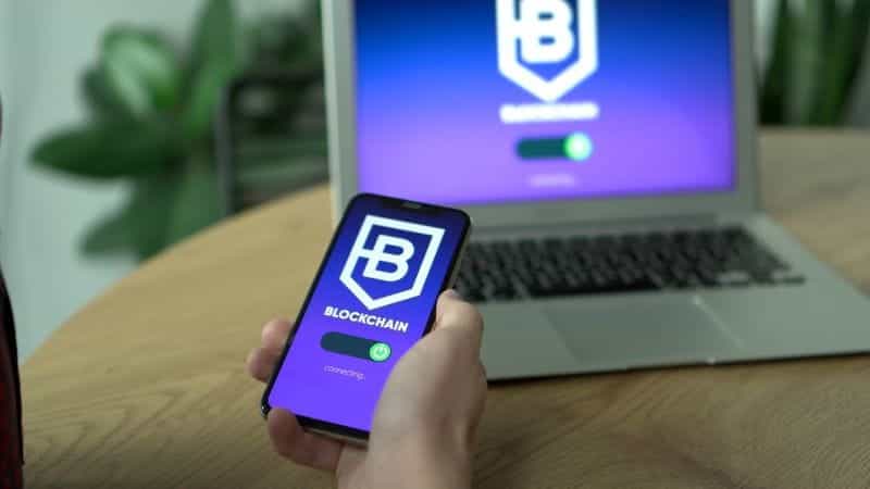 A laptop and a mobile phone showing the blockchain website.
