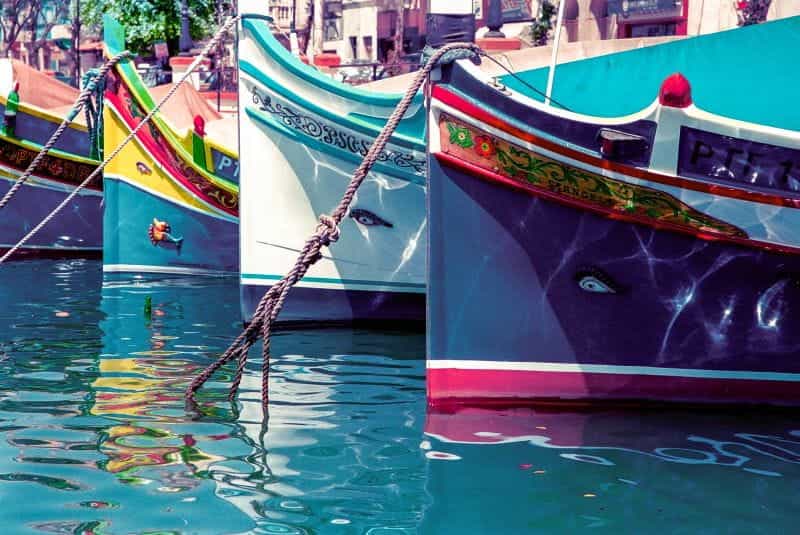 Red and brown boat on water.