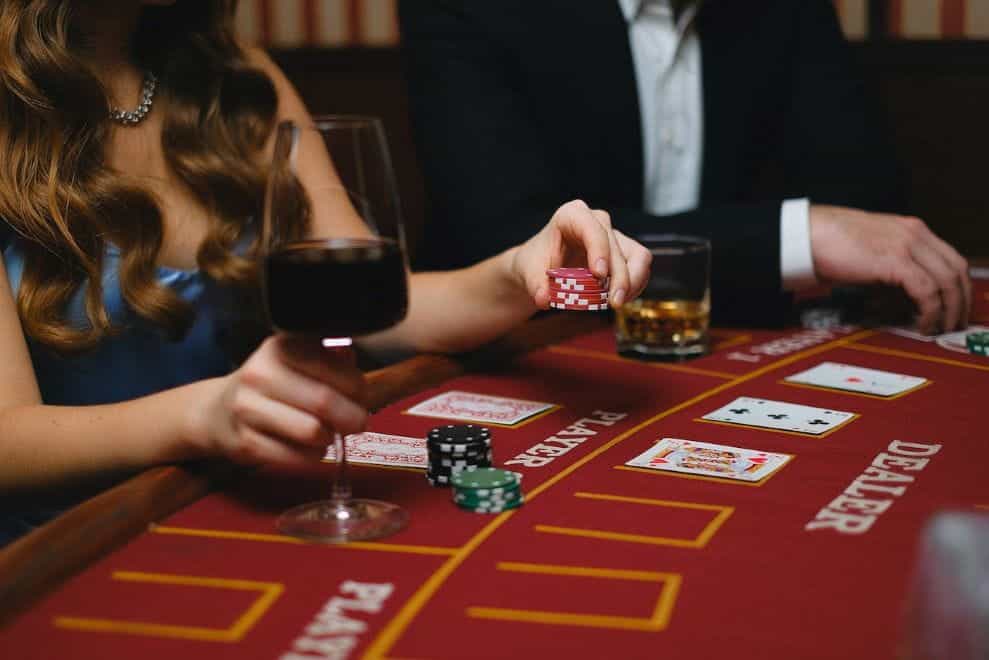 A man and a woman playing poker at a casino.