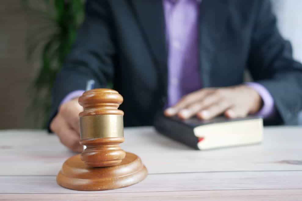 A judge with a book and a gavel.