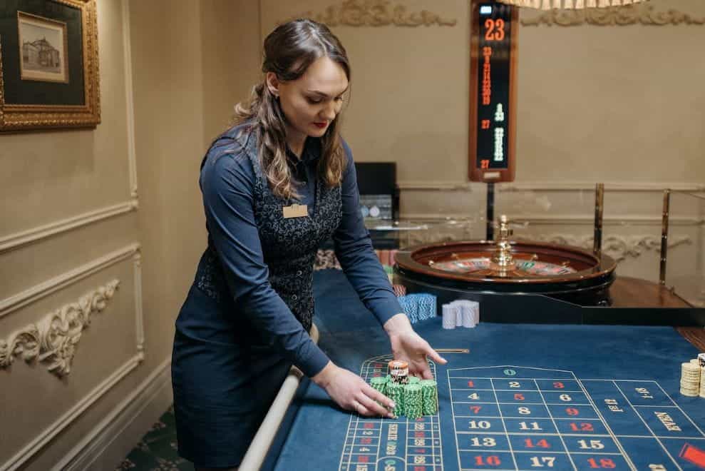 A croupier with poker chips in a casino.