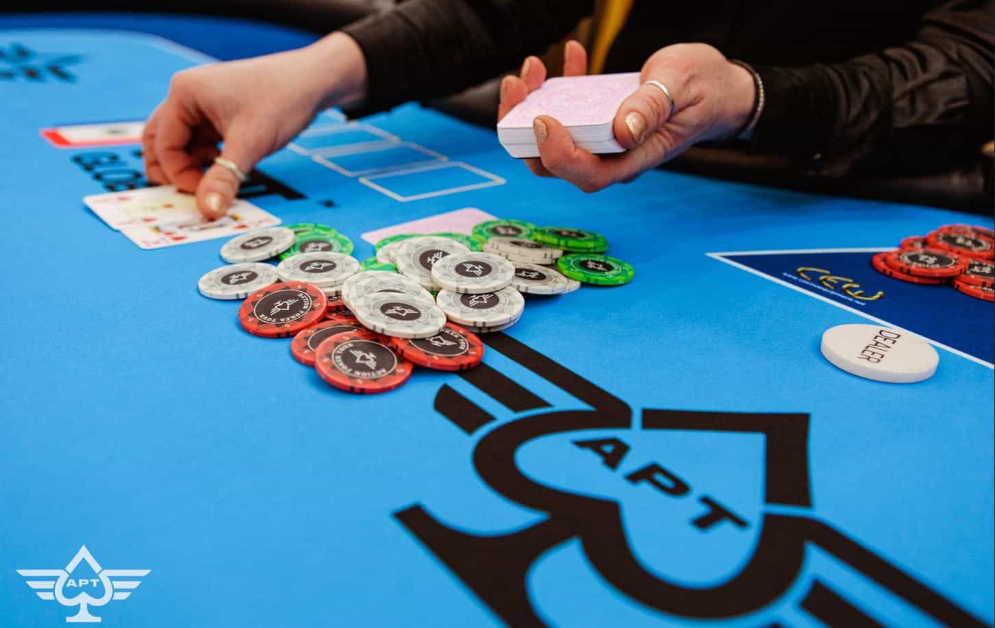 The dealer delivers a flop during a 2023 Action Poker Tour event.