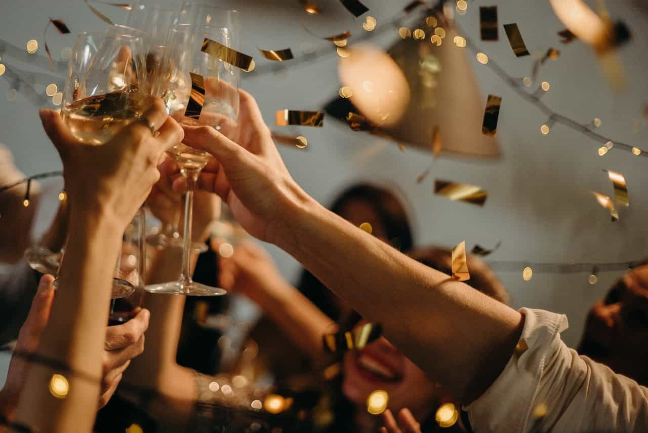People celebrating with wine and confetti.