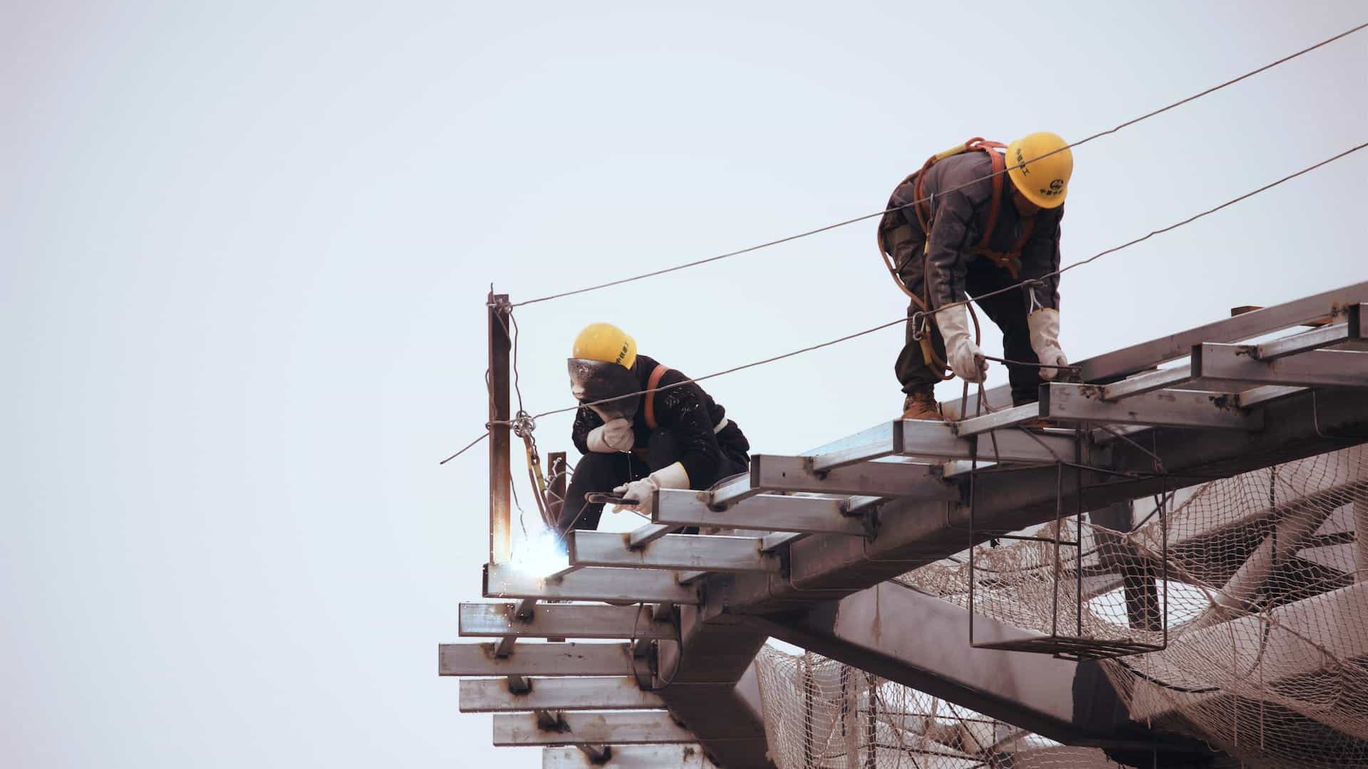 Construction workers work on an unfinished building.