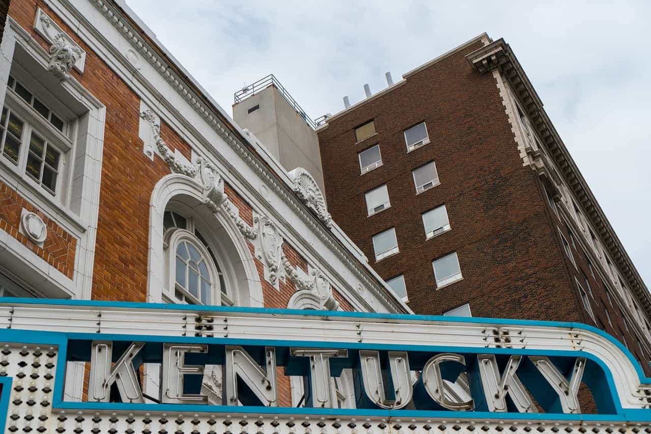 The large marquee of a theater in an American town with the word “Kentucky” displayed on it in large writing.