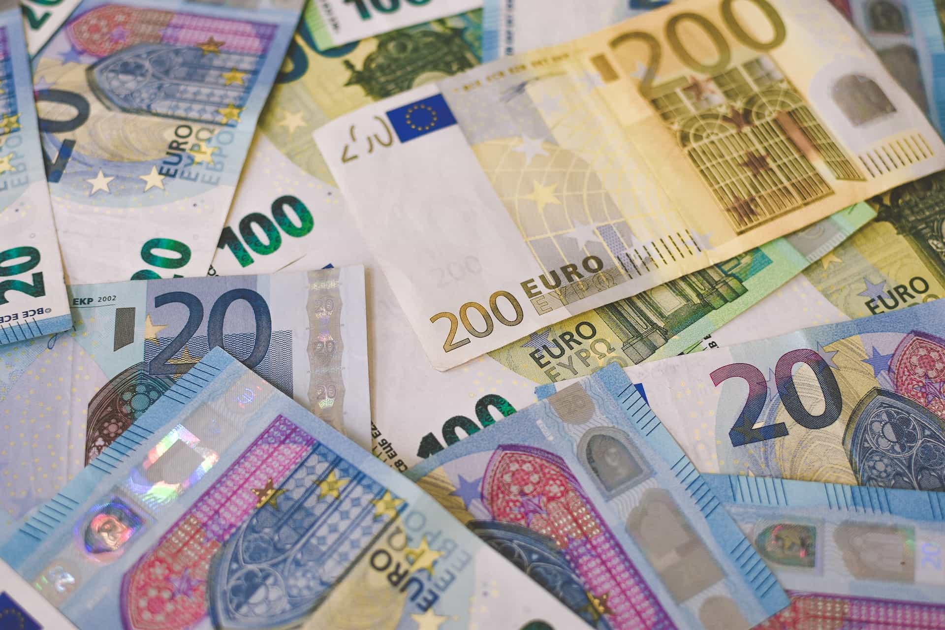 A pile of Euro (EUR) banknotes that include 20, 100, and 200 Euro denominations.