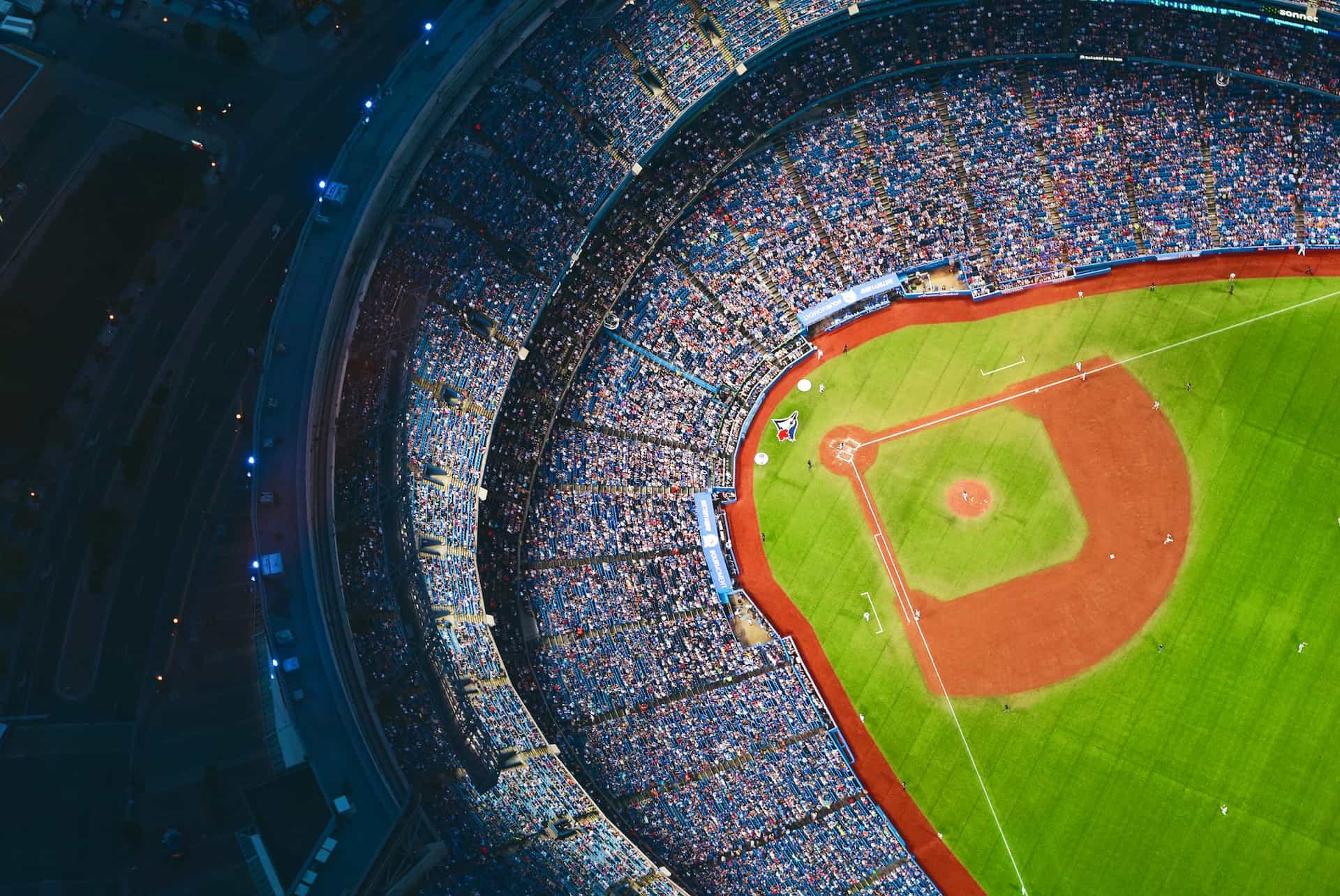 A top-down aerial view of a baseball stadium during a big game, with the baseball diamond clearly seen.