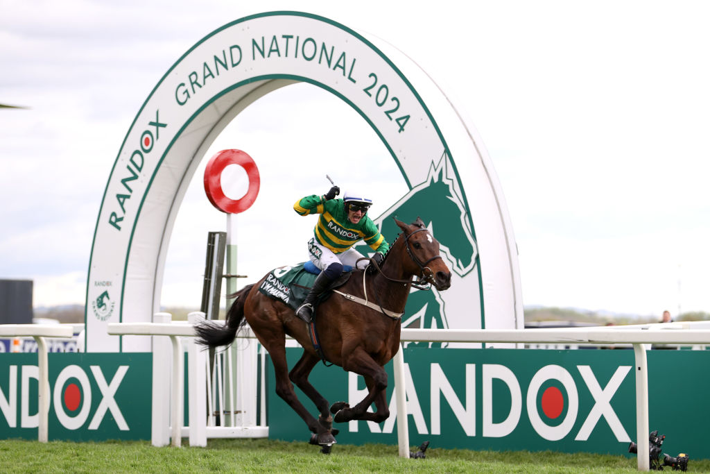 Paul Townend celebrates on board I Am Maximus as the pair cross the line ahead in the 2024 Grand National.
